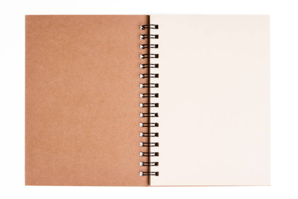 istock Isolated notebook. Top view of spiral kraft notebook front, open page on background for mockup with clipping path. 1326393956