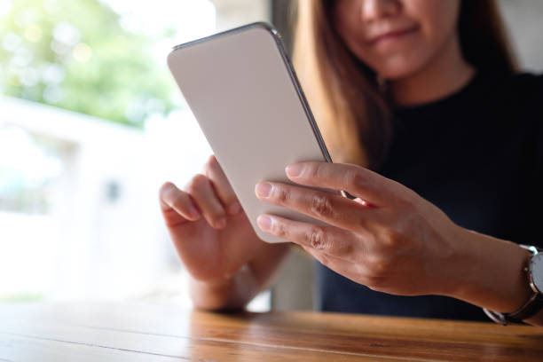 istock a beautiful young asian woman holding and using mobile phone 1326394152