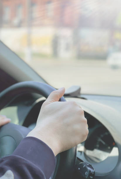 istock Man's hands driving a car while driving. Travel concept. 1326394911