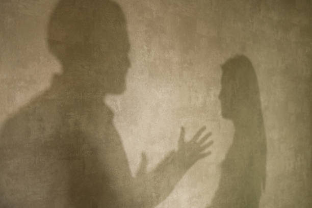 istock Silhouette on the wall of a couple talking. 1326397764