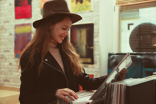 Young woman with vinyl record in store