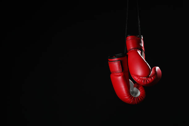 Pair Of Red Boxing Gloves Hanging On Black Background Space For Text Stock  Photo - Download Image Now - iStock