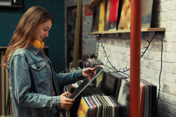 istock Young woman with vinyl record in store 1326399850