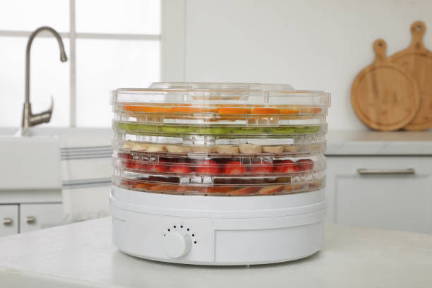 https://media.istockphoto.com/id/1326400917/photo/dehydrator-machine-with-different-fruits-and-berries-on-white-table-in-kitchen.jpg?s=612x612&w=0&k=20&c=3tWds70_61W176cOkGo8DqujTsI-vtzdkq8G4SOy1kA=