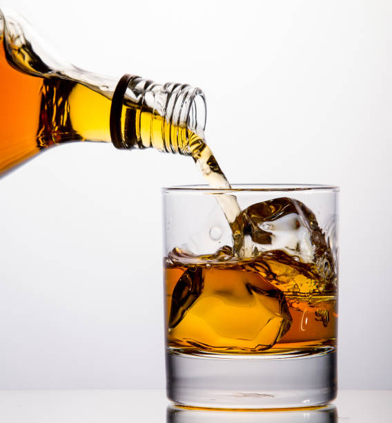 istock Pouring whisky from a bottle 1326402526