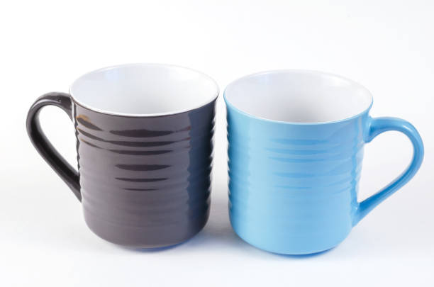 istock Two elegant ceramic mugs on a white background. Gray and blue cu 1326403282