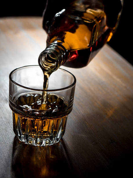 istock Pouring whisky into a glass 1326403503