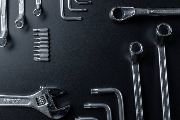istock Metal tools. Metallic wrenches for home manual repair work. Set of hardware tool for construction on dark background. Construction tooling board with copy space maintenance concept. 1326403762