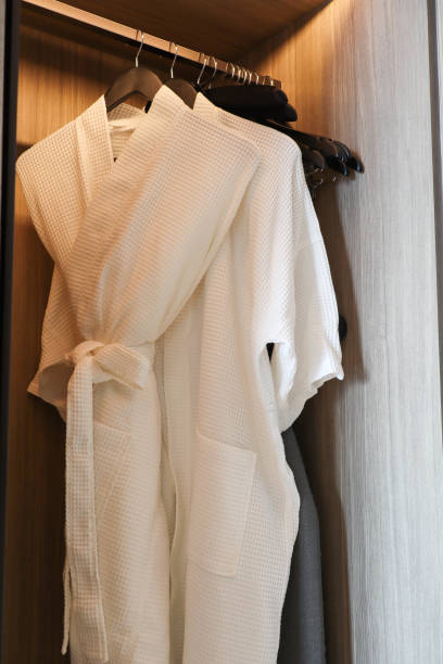 istock White clean bathrobe hanging in the closet 1326404503