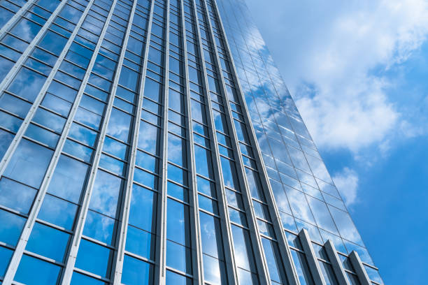 istock Blue sky and clouds reflected at glass wall 1326404711