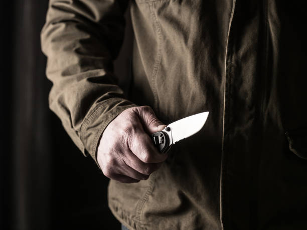 istock Man holding a knife in a threatening stance 1326407319