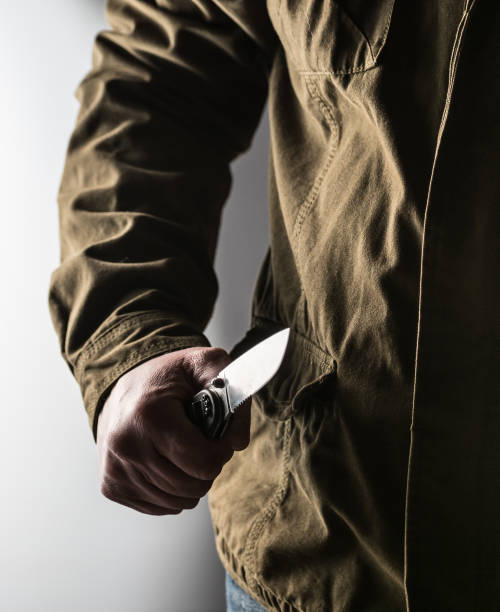 istock Man holding a knife in a threatening stance 1326407380