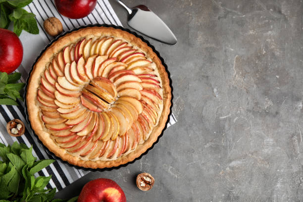 istock Flat lay composition with delicious homemade apple tart on grey table. Space for text 1326409171