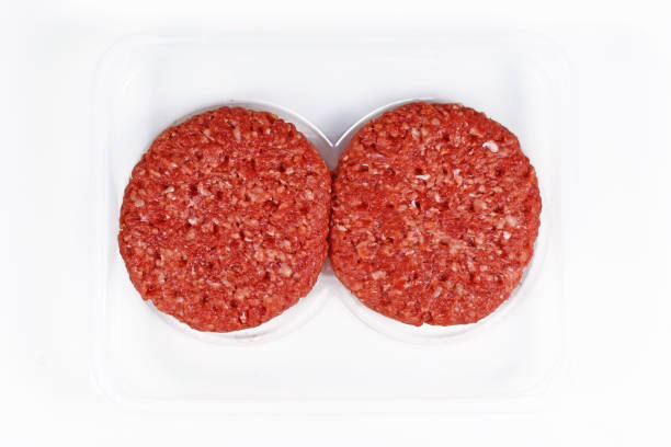 istock Two raw round burger patties in package 1326411229