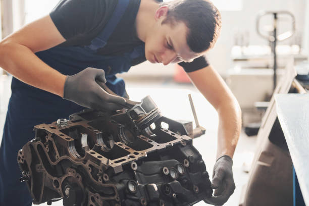 istock Professional repairman works with broken automobile engine 1326411437