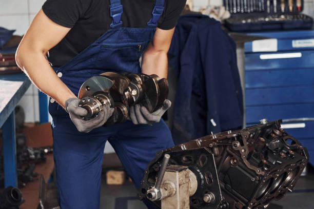 istock Professional repairman in garage works with broken automobile engine 1326411586