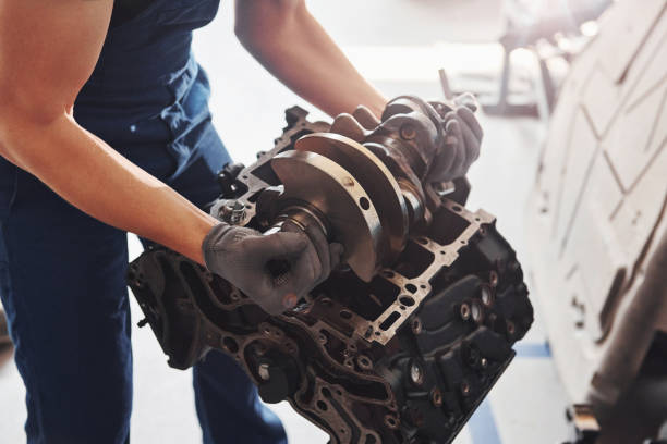 istock Professional repairman works with broken automobile engine 1326411629