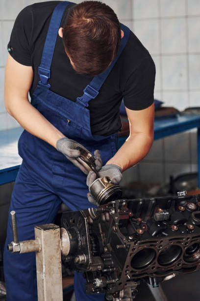 istock Professional repairman in garage works with broken automobile engine 1326411705