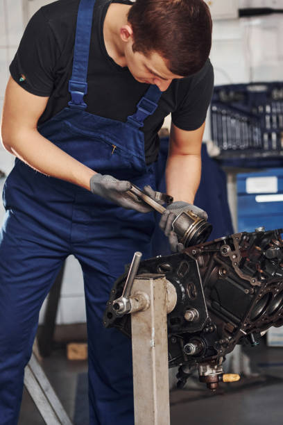 istock Professional repairman in garage works with broken automobile engine 1326411721