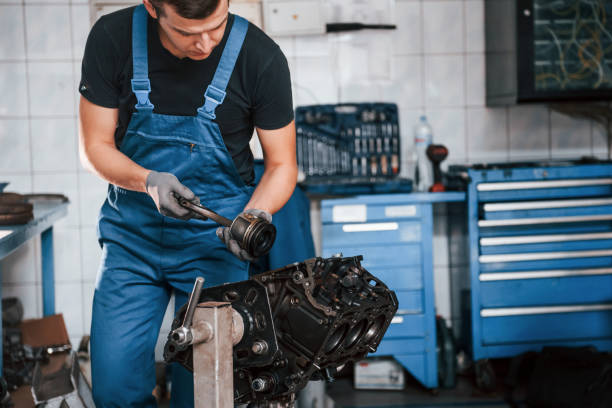 istock Professional repairman in garage works with broken automobile engine 1326411855