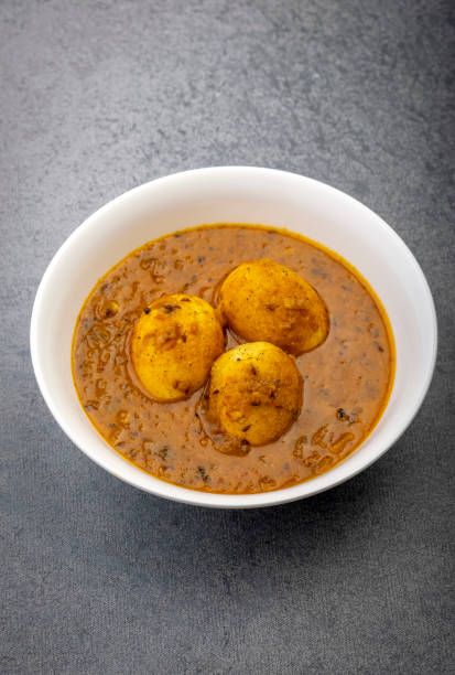 istock Fried egg curry or Anda Masala served in a white bowl and copy space 1326411864