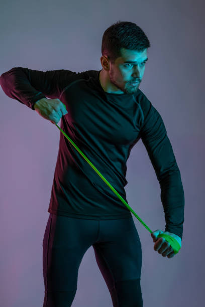 istock Focused muscular male exercising with resistance band loop 1326412561