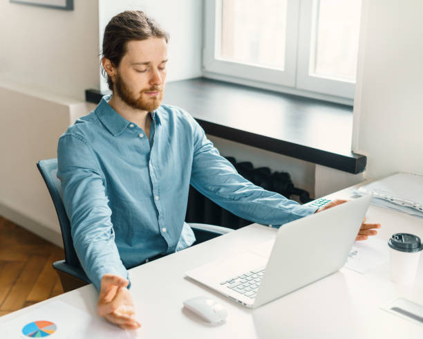 istock Calm male office worker meditating with closed eyes at work 1326413157