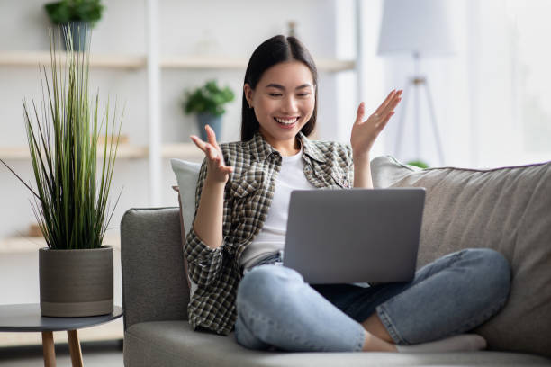 istock Happy asian woman having video chat with her lover 1326414363