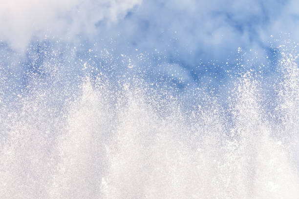 background of water jets and fountain splashes against a blue sky with clouds - well fountain water pipe pipe imagens e fotografias de stock