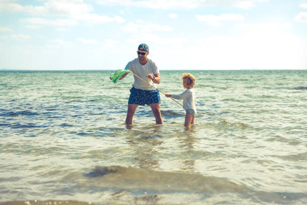 istock Father and daughter outdoor on beach 1326417303