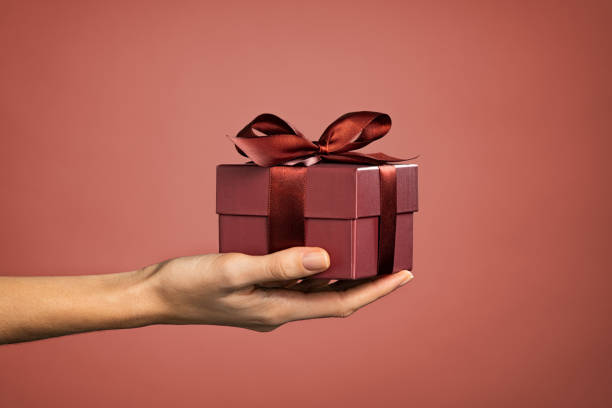 istock Woman hand holding elegant gift box 1326419179