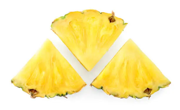 Photo of Pineapple slices isolate. Cut pineapples on white. Fresh pineapple set top viw. Full depth of field.