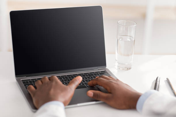 istock Online consultation. Unrecognizable african american doctor using laptop computer with empty screen, free space 1326420426