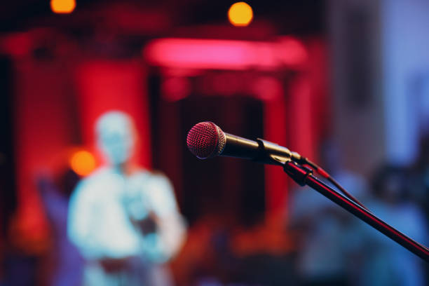 microphone without people on stage with colorful lights of stand-up show Concept stock photo
