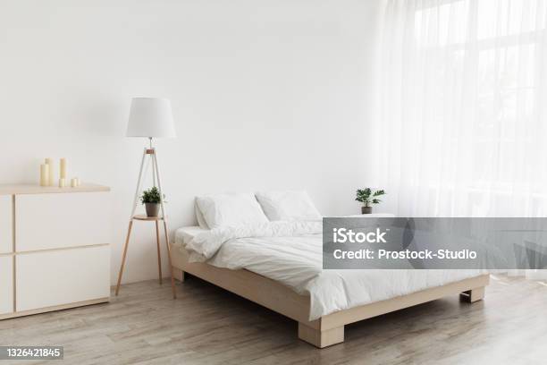 Simple Modern Design Ad Offer Double Bed With White Pillows And Soft Blanket Lamp Furniture On Wooden Floor Stock Photo - Download Image Now