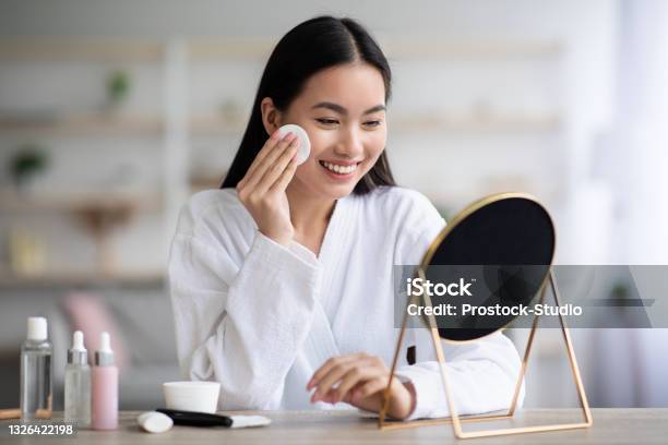 Beautiful Asian Woman Cleaning Her Face With Toner Stock Photo - Download Image Now - Skin Care, Make-Up, Women