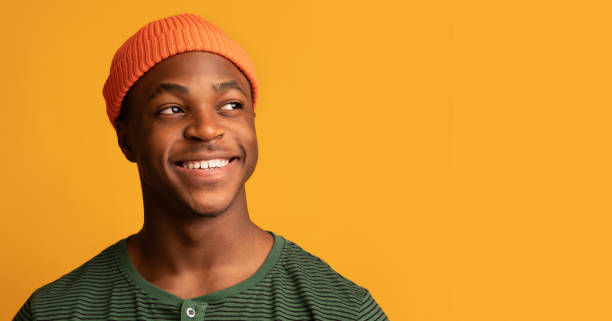 istock Smiling African American Hispter Guy Looking Aside At Copy Space With Interest 1326422497