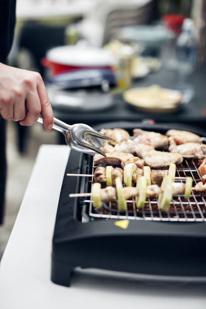 istock Preparing barbeque on a electrical modern grill outdoors. 1326422559