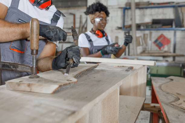 istock A Carpenter with Protective Workwear is Working in Carpentry Workshop with his Colleagues. 1326423103