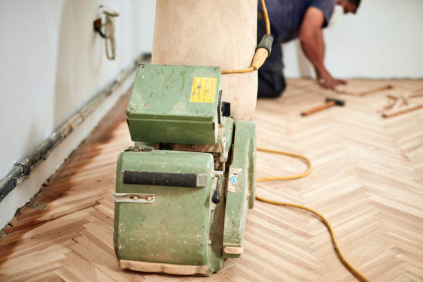 istock Repairman restoring parquet with a sanding machine. 1326423238