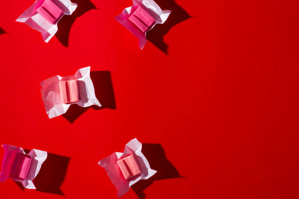 istock Pink gum on a red background 1326423439