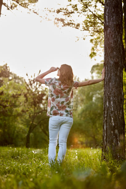 istock Woman in park outdoors feeling happy and powerful. 1326423480