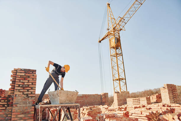 istock Using showel. Construction worker in uniform and safety equipment have job on building 1326423699