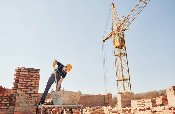 istock Using showel. Construction worker in uniform and safety equipment have job on building 1326423741