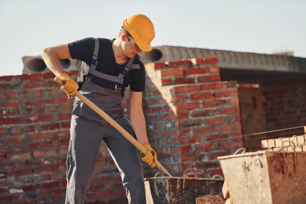 istock Using showel. Construction worker in uniform and safety equipment have job on building 1326424539