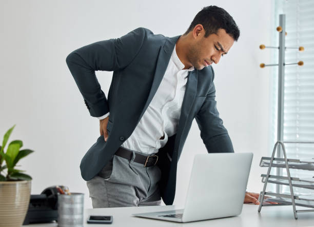 istock .shot of a businessman suffering backache in a modern office 1326424724