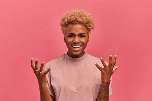 istock Angry dark skinned woman disagrees raising her hands with an irritated expression. 1326426263