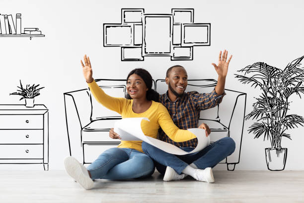 istock Young African American Spouses Holding House Plan And Dreaming About Interior Design 1326427326