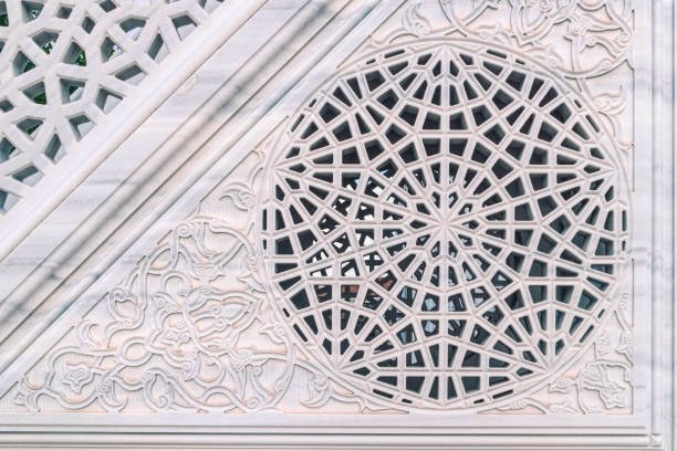 Luxurious interior decor in oriental style. Light marble stone wall with carved oriental floral pattern. Background and texture