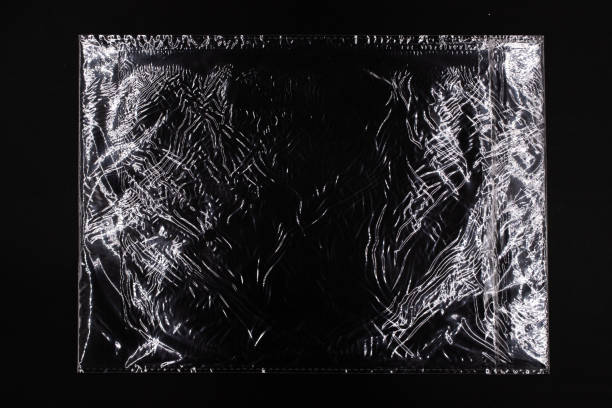 istock Glossy plastic bag on black background, glare texture of plastic file 1326428797